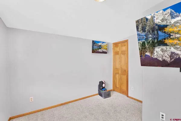 a view of a room with a painting on the wall