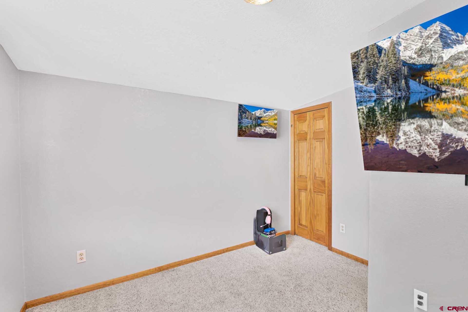 a view of a room with a painting on the wall