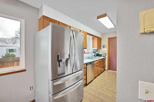 a kitchen with stainless steel appliances a refrigerator sink and cabinets