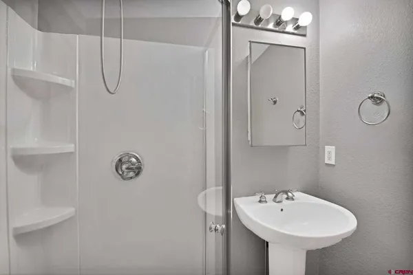 a bathroom with a sink and mirror