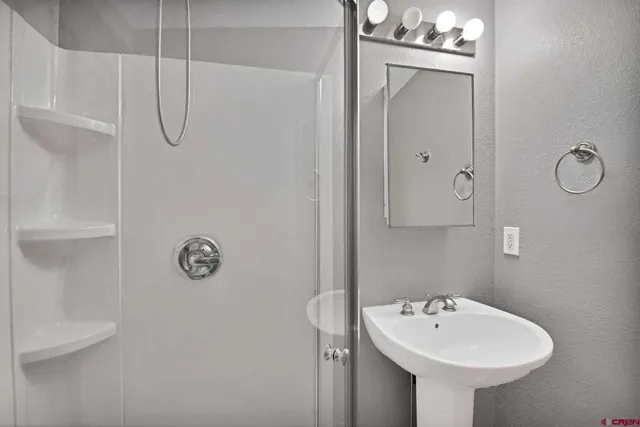 a bathroom with a sink and mirror