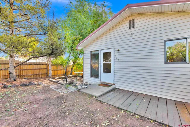 a view of backyard with a table and chair and wooden floor