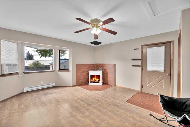 a view of an empty room with window and cabinet