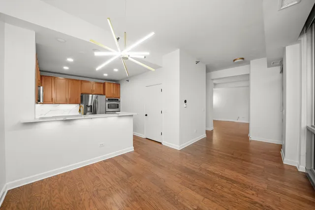 a view of kitchen with cabinets and wooden floor