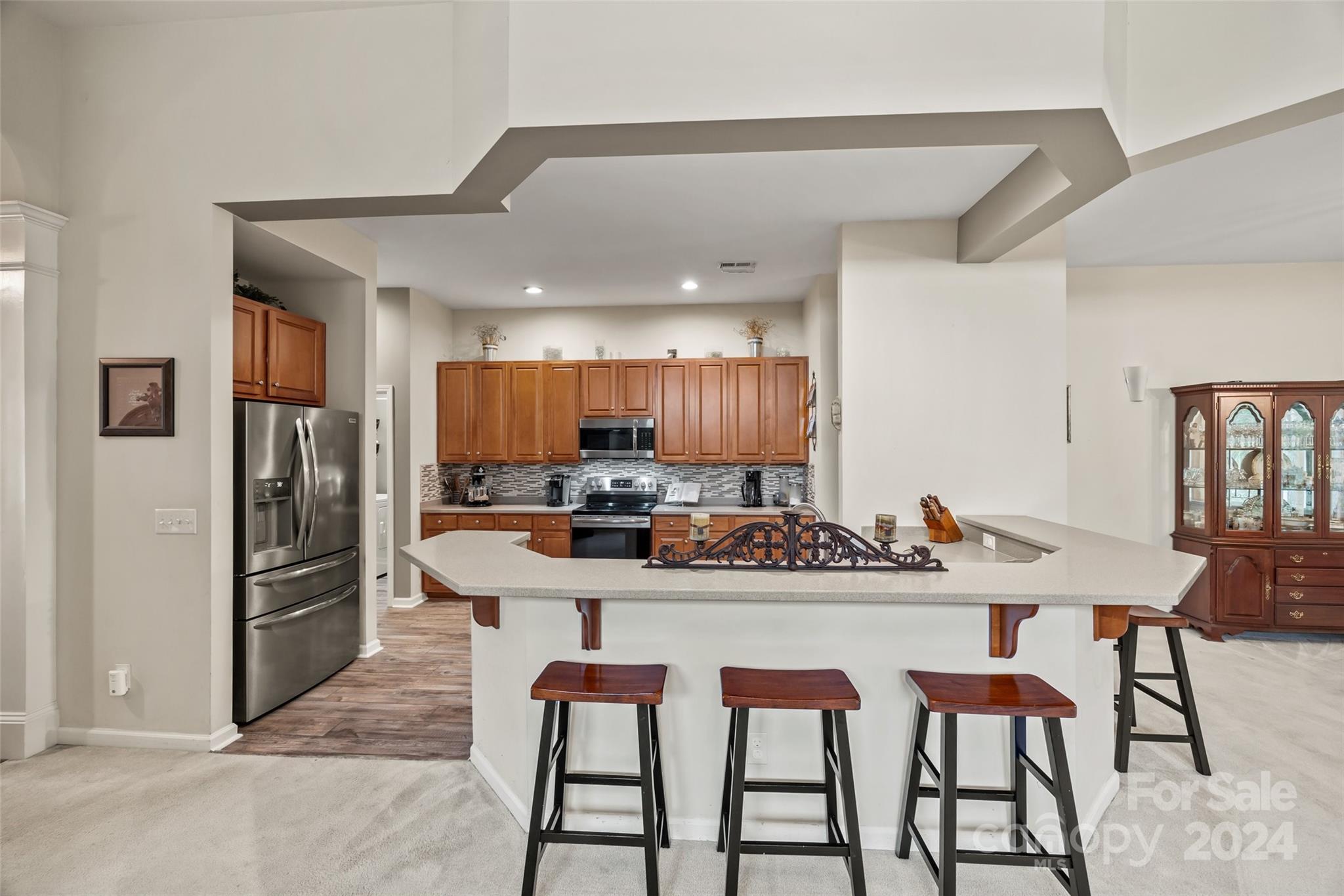 296 Sand Paver Way Fort Mill, SC 29708 - Photo 11 of 41 a kitchen with stainless steel appliances kitchen island granite countertop a dining table and chairs