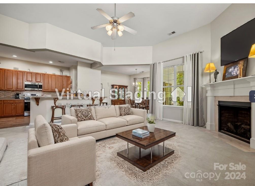 296 Sand Paver Way Fort Mill, SC 29708 - Photo 13 of 41 a living room with furniture a fireplace and a flat screen tv
