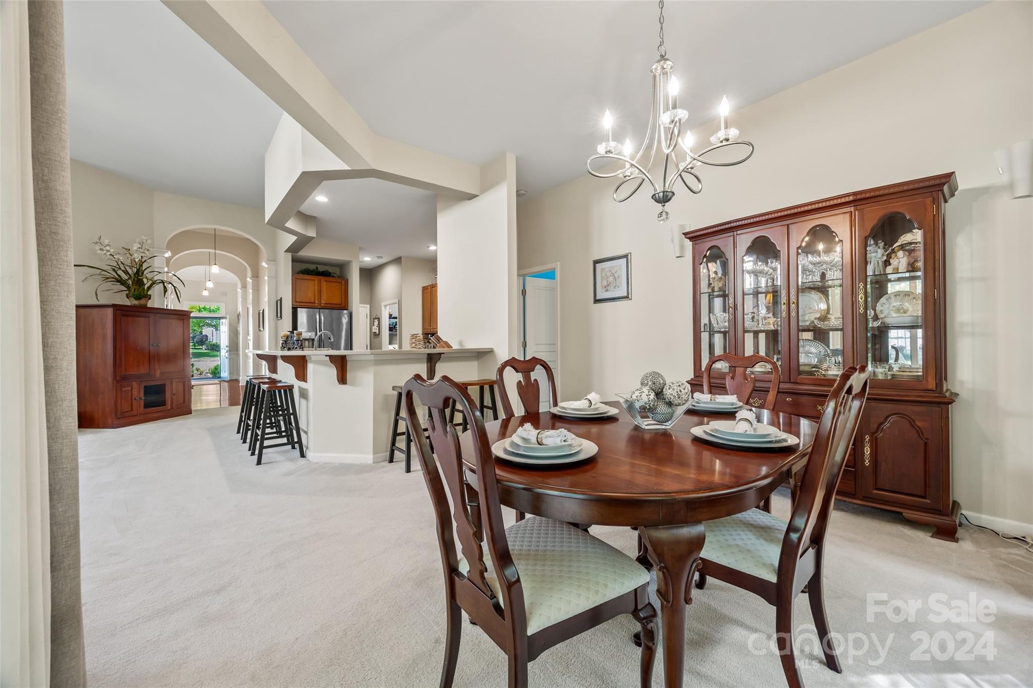 296 Sand Paver Way Fort Mill, SC 29708 - Photo 16 of 41 a dining room with furniture a chandelier and wooden floor