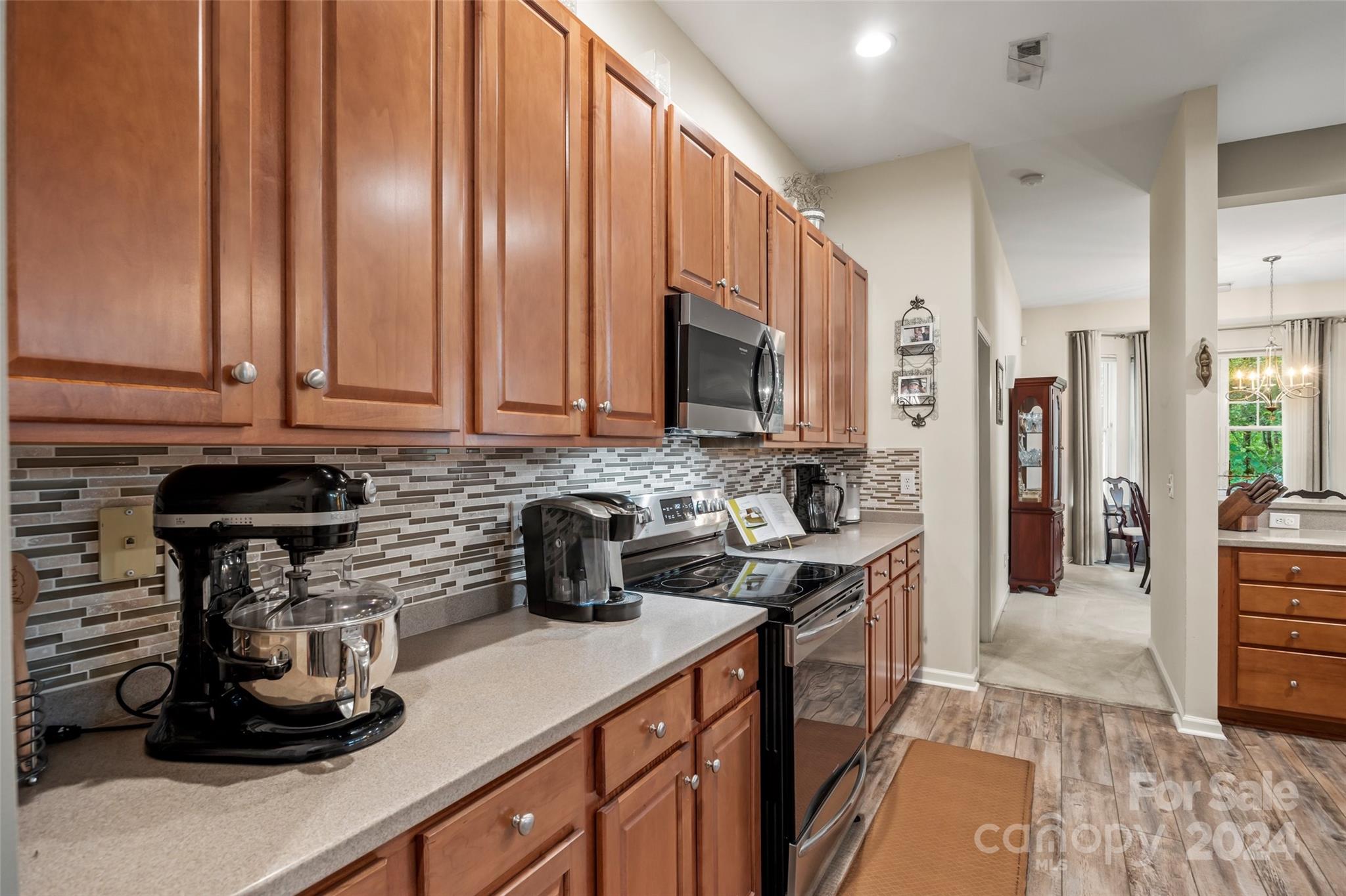 296 Sand Paver Way Fort Mill, SC 29708 - Photo 9 of 41 a kitchen with stainless steel appliances granite countertop a sink stove and cabinets