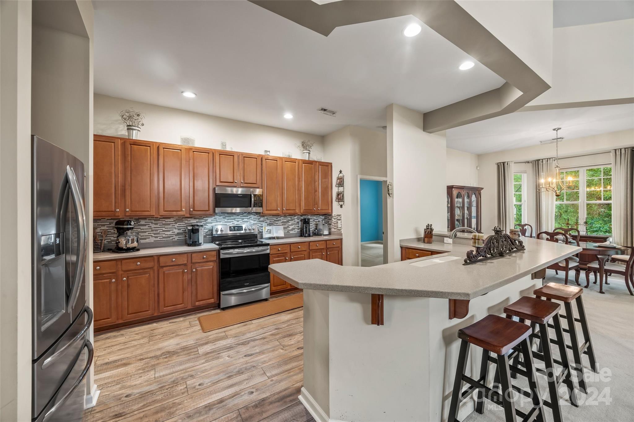 296 Sand Paver Way Fort Mill, SC 29708 - Photo 10 of 41 a kitchen with stainless steel appliances kitchen island granite countertop a stove refrigerator and cabinets