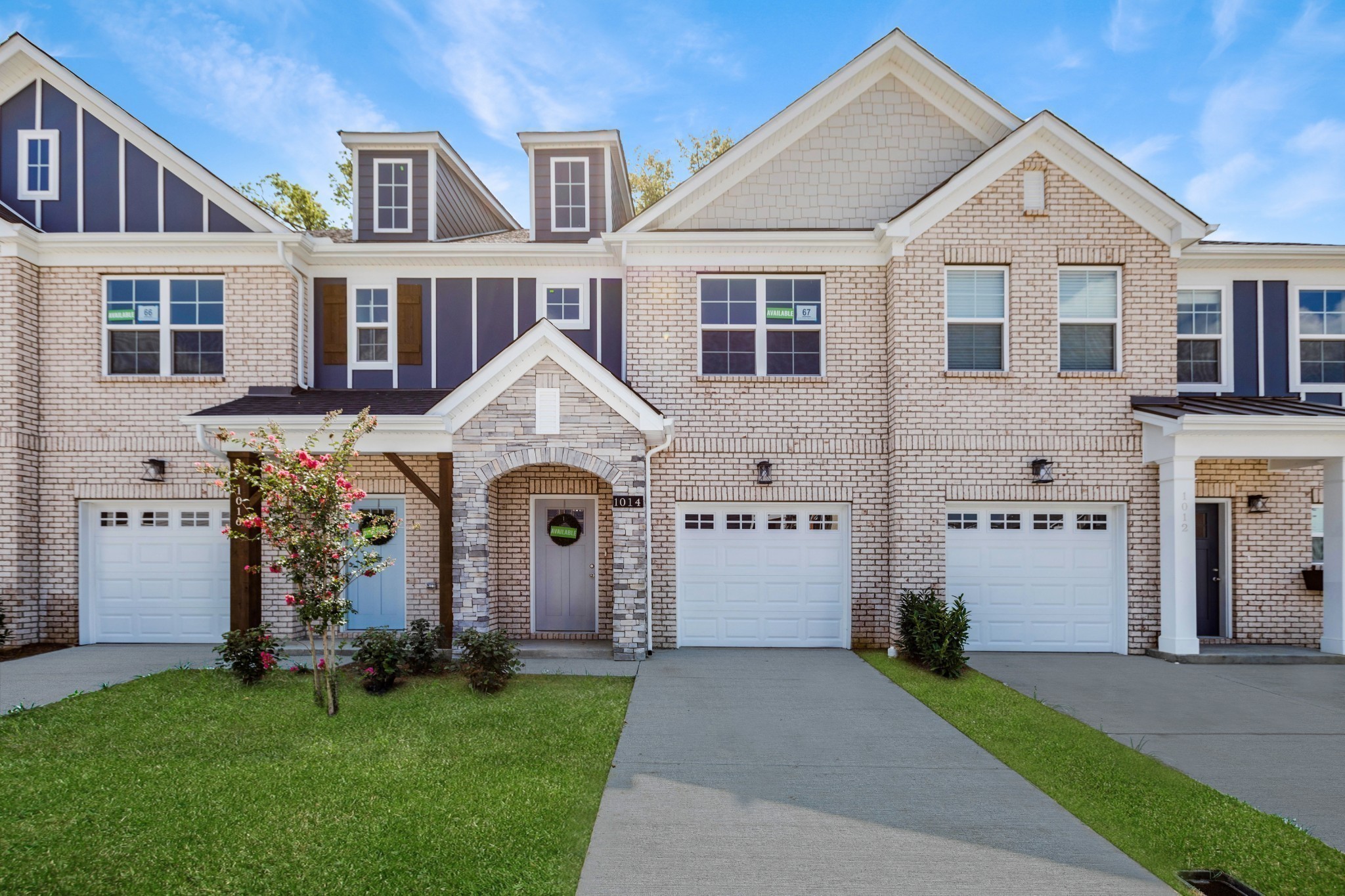 a front view of a house with a garden