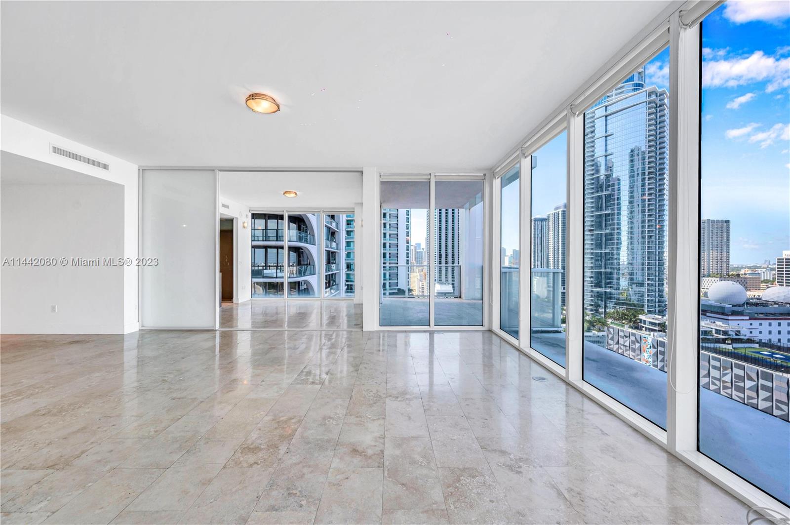 1040 Biscayne Boulevard, Unit 2107 Miami, FL 33132 - Photo 12 of 50 a view of an empty room with floor to ceiling window and an empty room