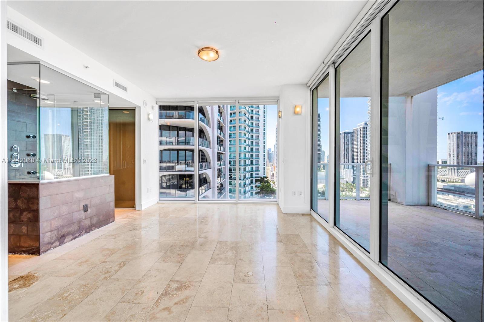 1040 Biscayne Boulevard, Unit 2107 Miami, FL 33132 - Photo 22 of 50 a view of an entryway with wooden floor and a living room