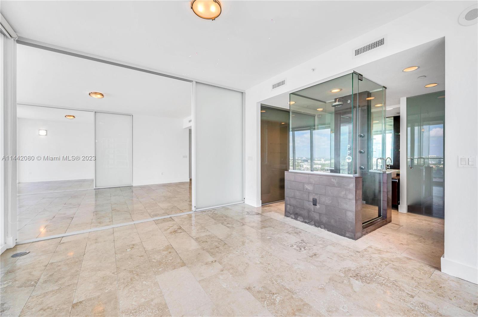 1040 Biscayne Boulevard, Unit 2107 Miami, FL 33132 - Photo 24 of 50 a view of a bathroom with a sink and a mirror