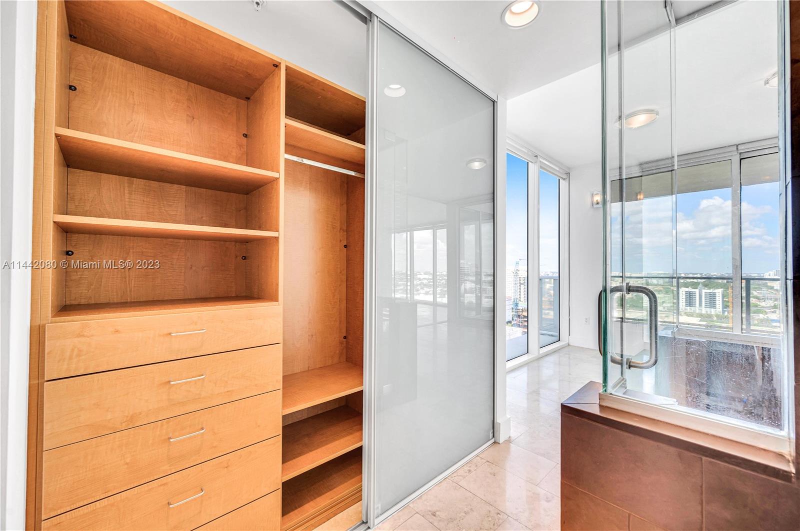 1040 Biscayne Boulevard, Unit 2107 Miami, FL 33132 - Photo 25 of 50 a view of walk in closet with empty racks