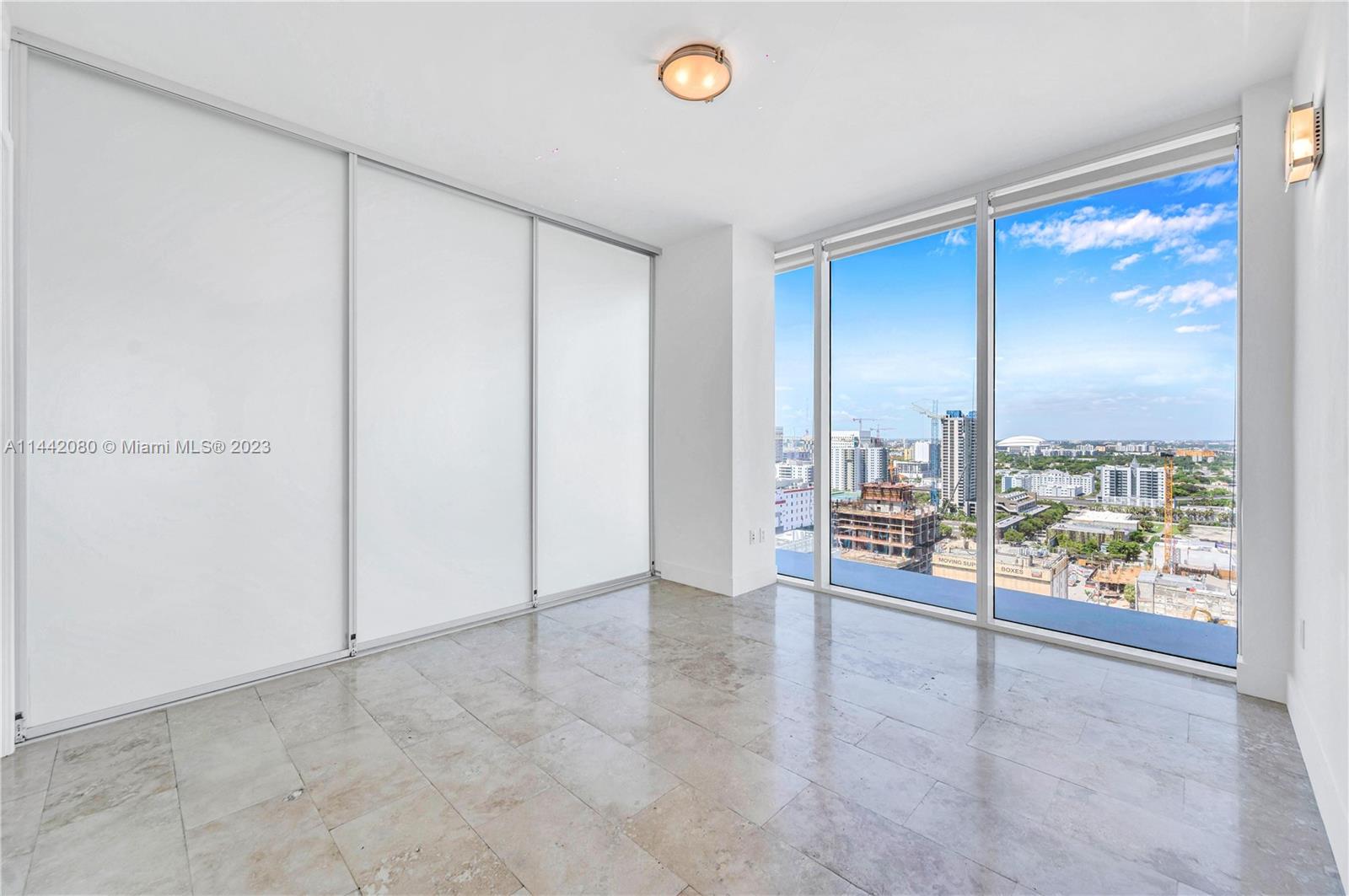 1040 Biscayne Boulevard, Unit 2107 Miami, FL 33132 - Photo 27 of 50 a view of an empty room with a window