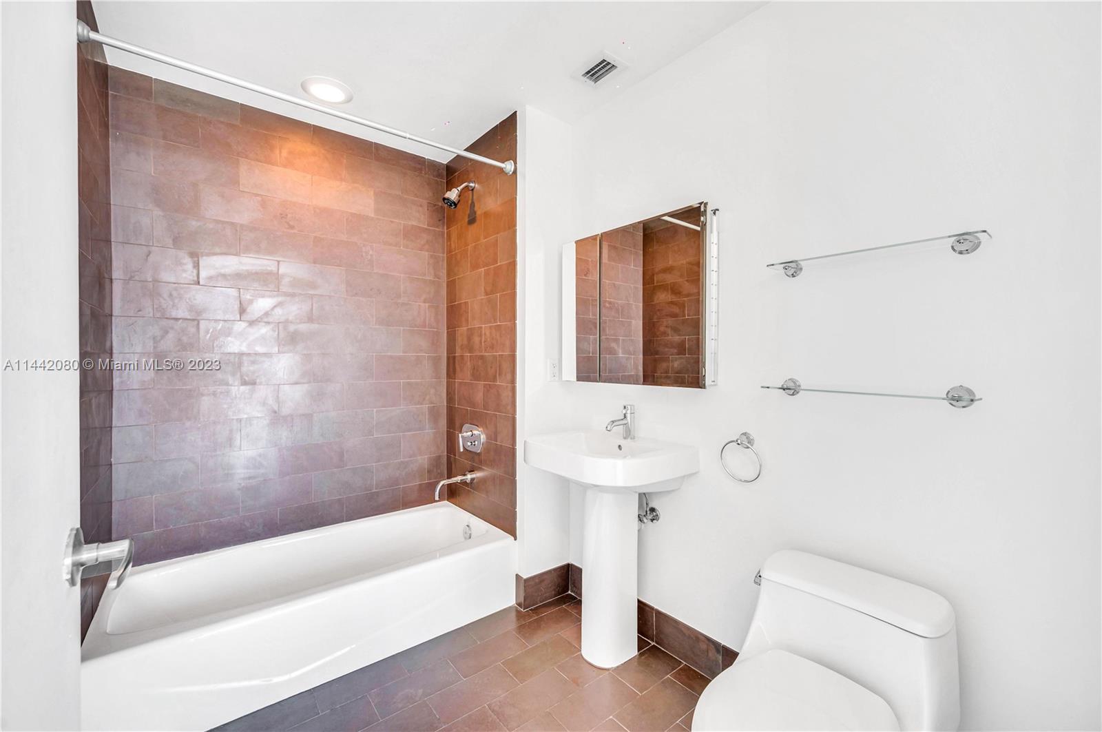 1040 Biscayne Boulevard, Unit 2107 Miami, FL 33132 - Photo 29 of 50 a bathroom with a sink toilet and shower