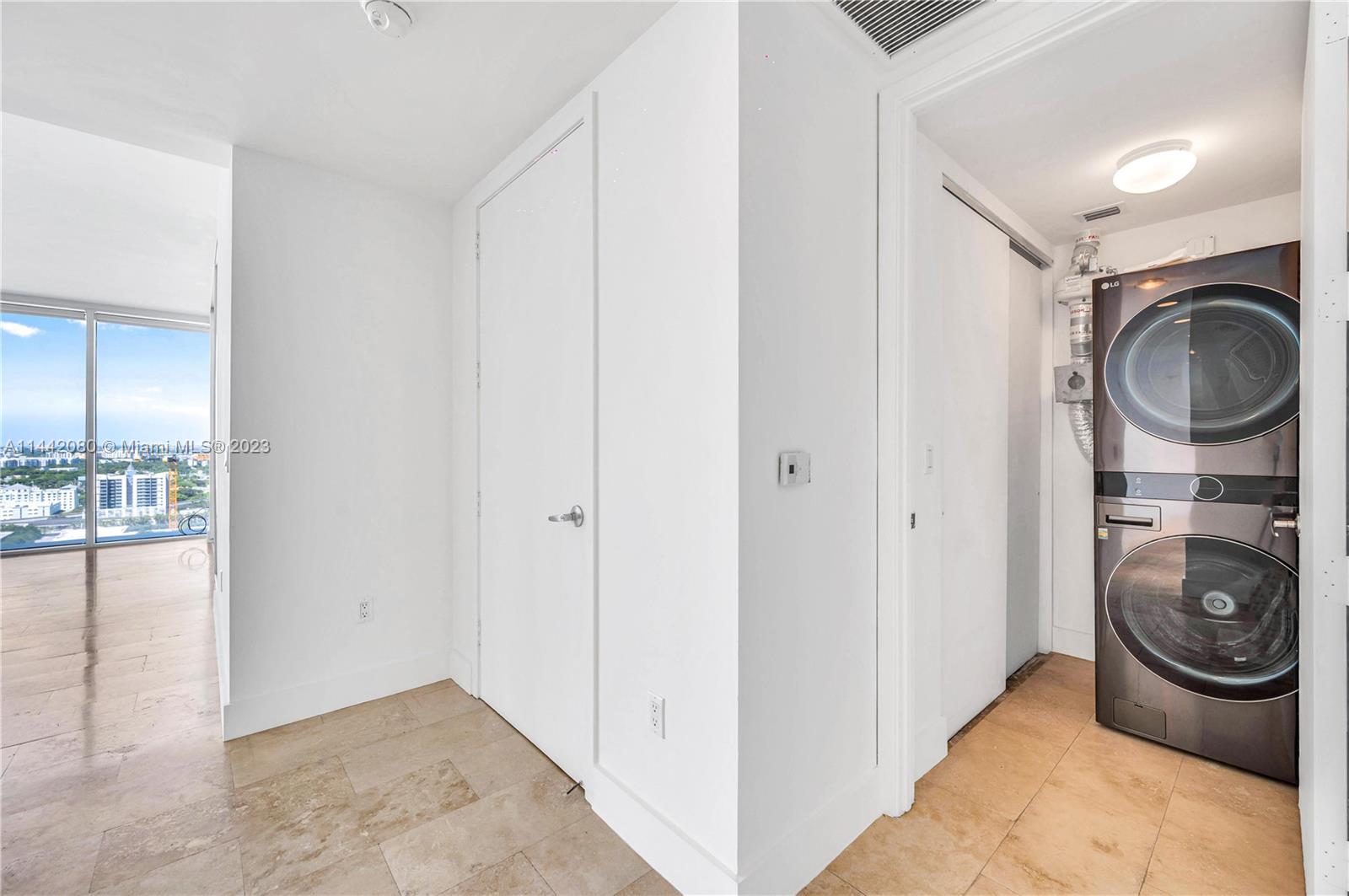 1040 Biscayne Boulevard, Unit 2107 Miami, FL 33132 - Photo 3 of 50 a storage room with washer and dryer