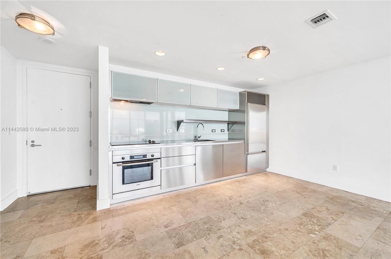 1040 Biscayne Boulevard, Unit 2107 Miami, FL 33132 - Photo 5 of 50 a view of a kitchen with a sink and a refrigerator