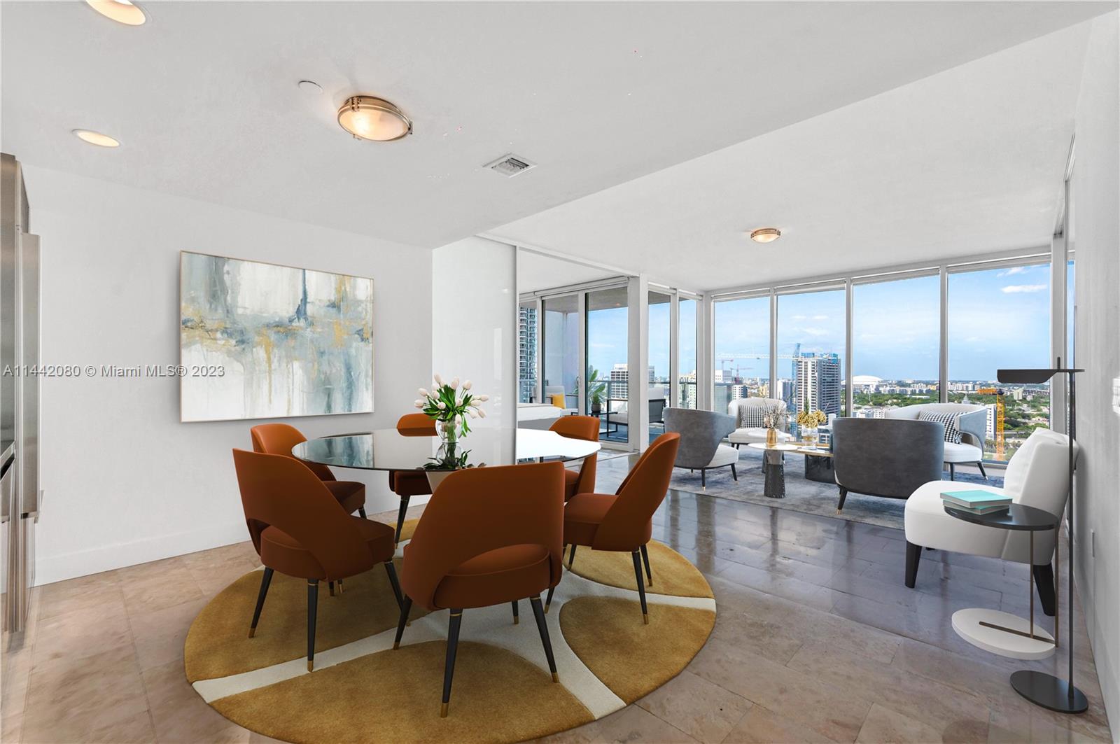 1040 Biscayne Boulevard, Unit 2107 Miami, FL 33132 - Photo 6 of 50 a dining room with furniture a rug and a large window