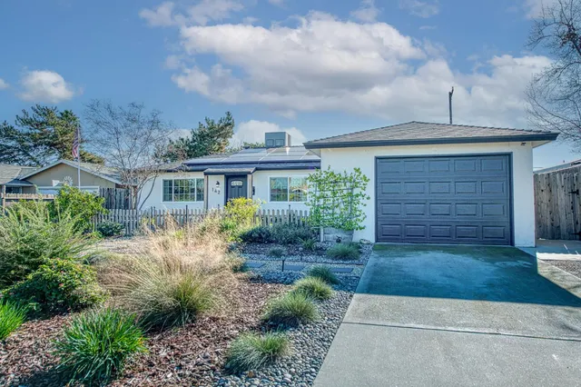 a front view of a house with garden