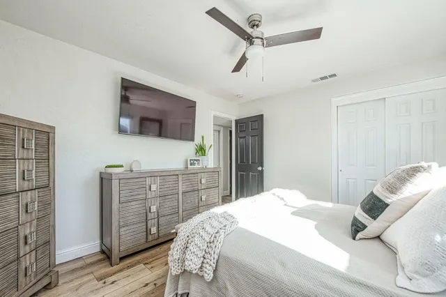 a bedroom with a bed and a flat screen tv