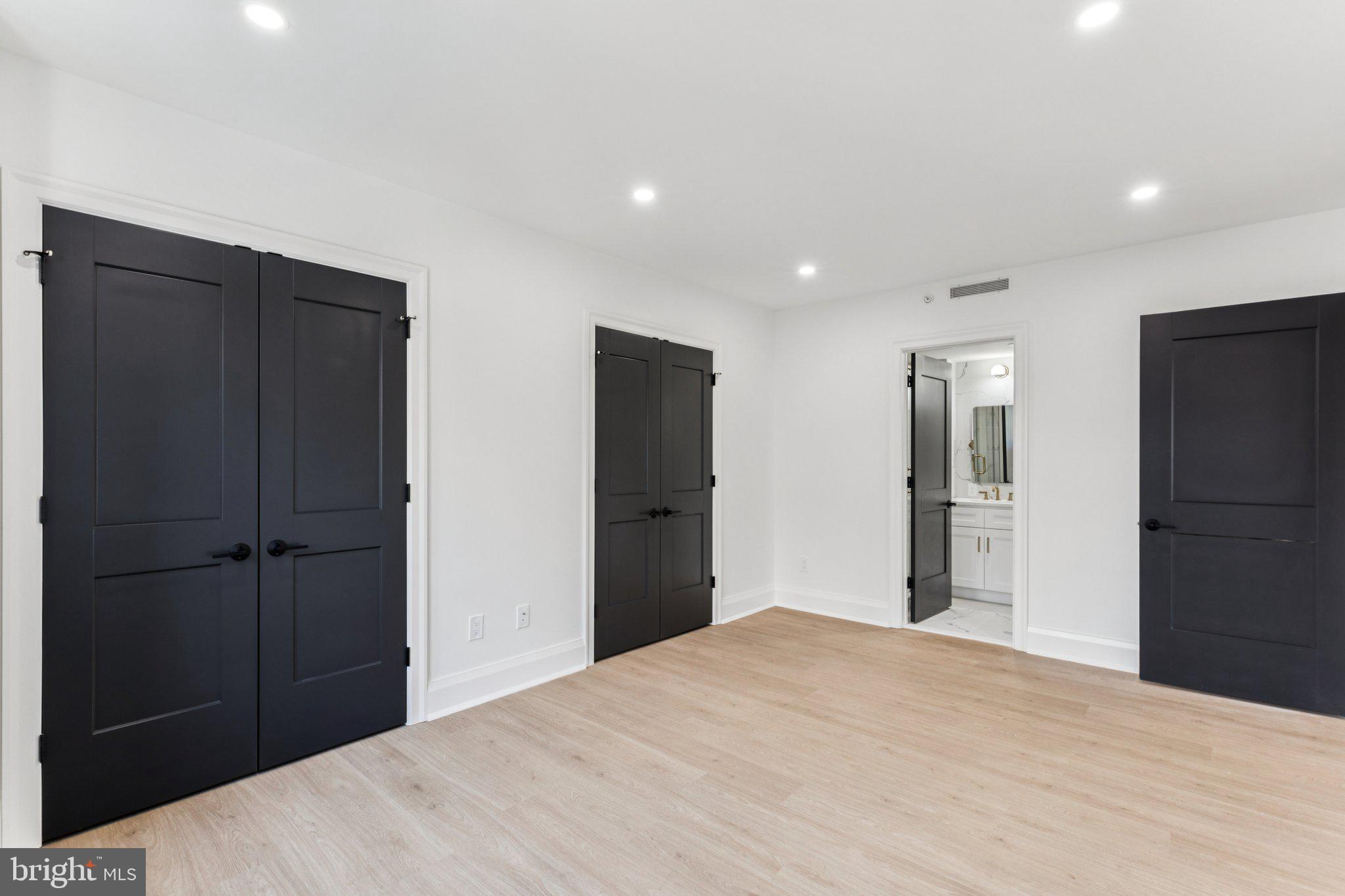 135 South 19th Street, Unit 308 Philadelphia, PA 19103 - Photo 11 of 24 a bedroom with a bed and a mirror