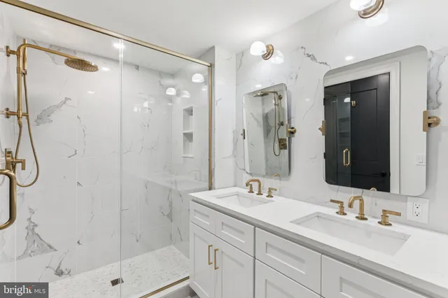 a bathroom with a shower sink and mirror