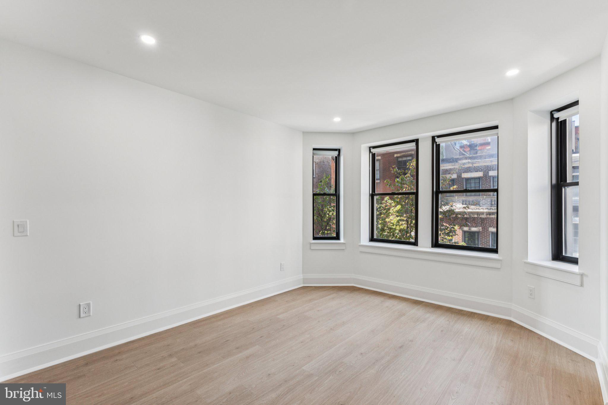 135 South 19th Street, Unit 308 Philadelphia, PA 19103 - Photo 13 of 24 wooden floor in an empty room with a window
