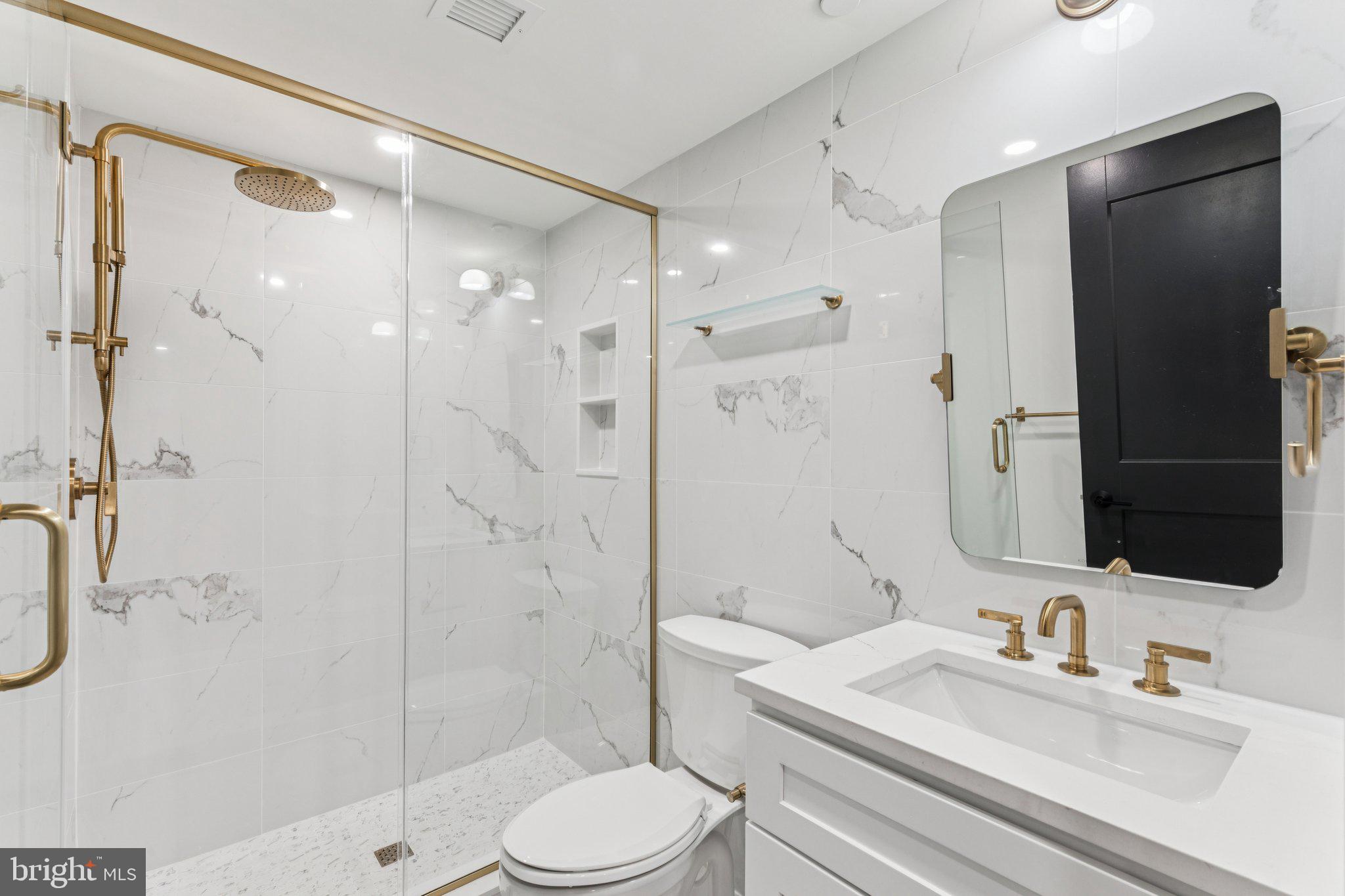 135 South 19th Street, Unit 308 Philadelphia, PA 19103 - Photo 15 of 24 a bathroom with a sink a toilet and shower