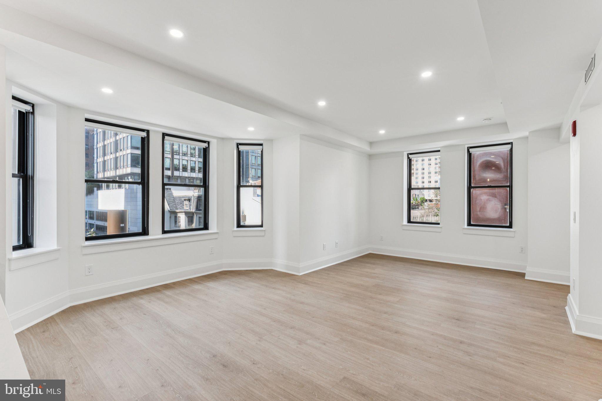 135 South 19th Street, Unit 308 Philadelphia, PA 19103 - Photo 2 of 24 wooden floor in an empty room with a window