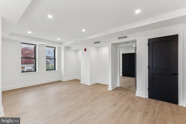 a view of empty room with wooden floor