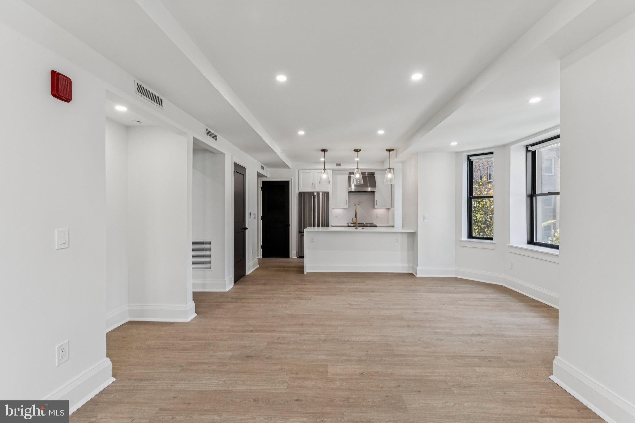 135 South 19th Street, Unit 308 Philadelphia, PA 19103 - Photo 4 of 24 a view of a kitchen with a sink and a refrigerator