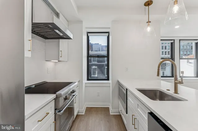 a kitchen that has a sink and cabinets