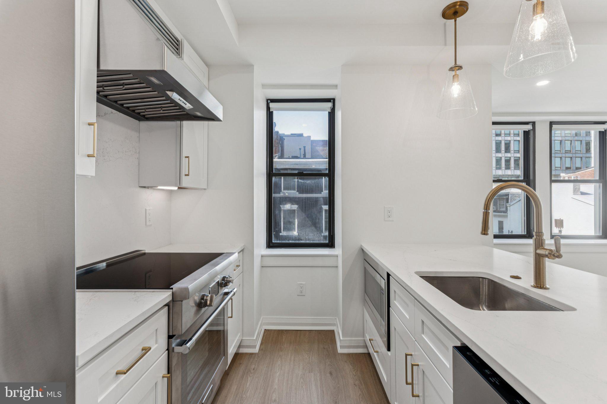 135 South 19th Street, Unit 308 Philadelphia, PA 19103 - Photo 7 of 24 a kitchen that has a sink and cabinets