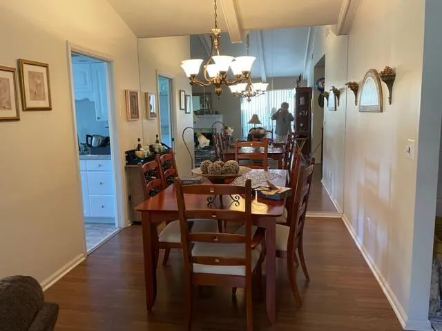 a view of a dining room with furniture and chandelier