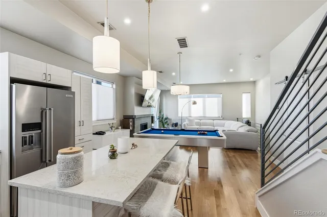 a kitchen with sink refrigerator and microwave