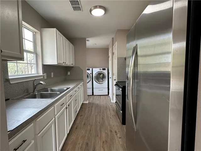 a kitchen with a sink and refrigerator