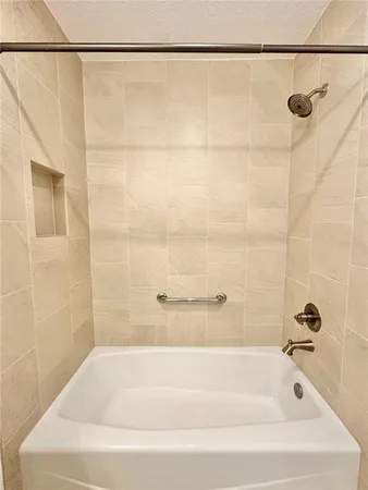 a bathroom with a shower and a bath tub
