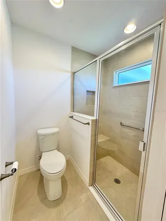 a bathroom with a toilet and a shower