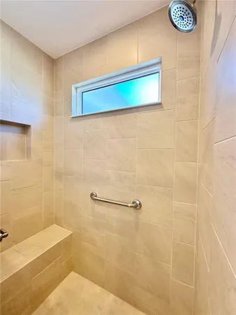 a bathroom with a shower and a sink