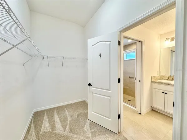 a view of a big room with wooden floor and closet area