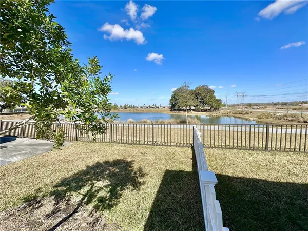 a view of a deck with wooden floor and fence