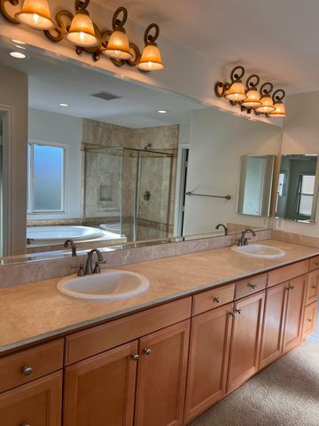 a bathroom with a double vanity sink and a mirror