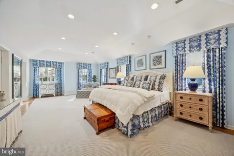 a spacious bedroom with a bed and window