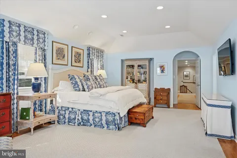 a spacious bedroom with a bed and a couch