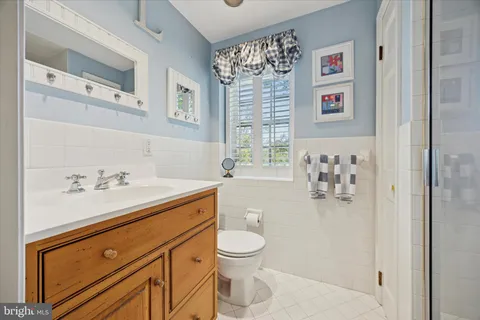 a bathroom with a sink a toilet and a shower