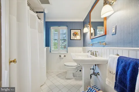 a bathroom with a toilet a sink and a mirror