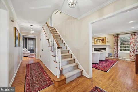 a view of a bedroom with wooden floor and stairs