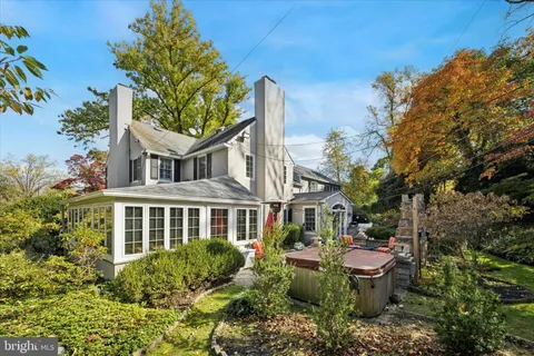 a view of a house with brick walls and flower plants