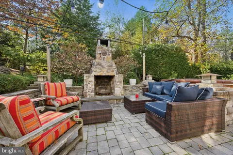 a outdoor living space with patio furniture and a fireplace